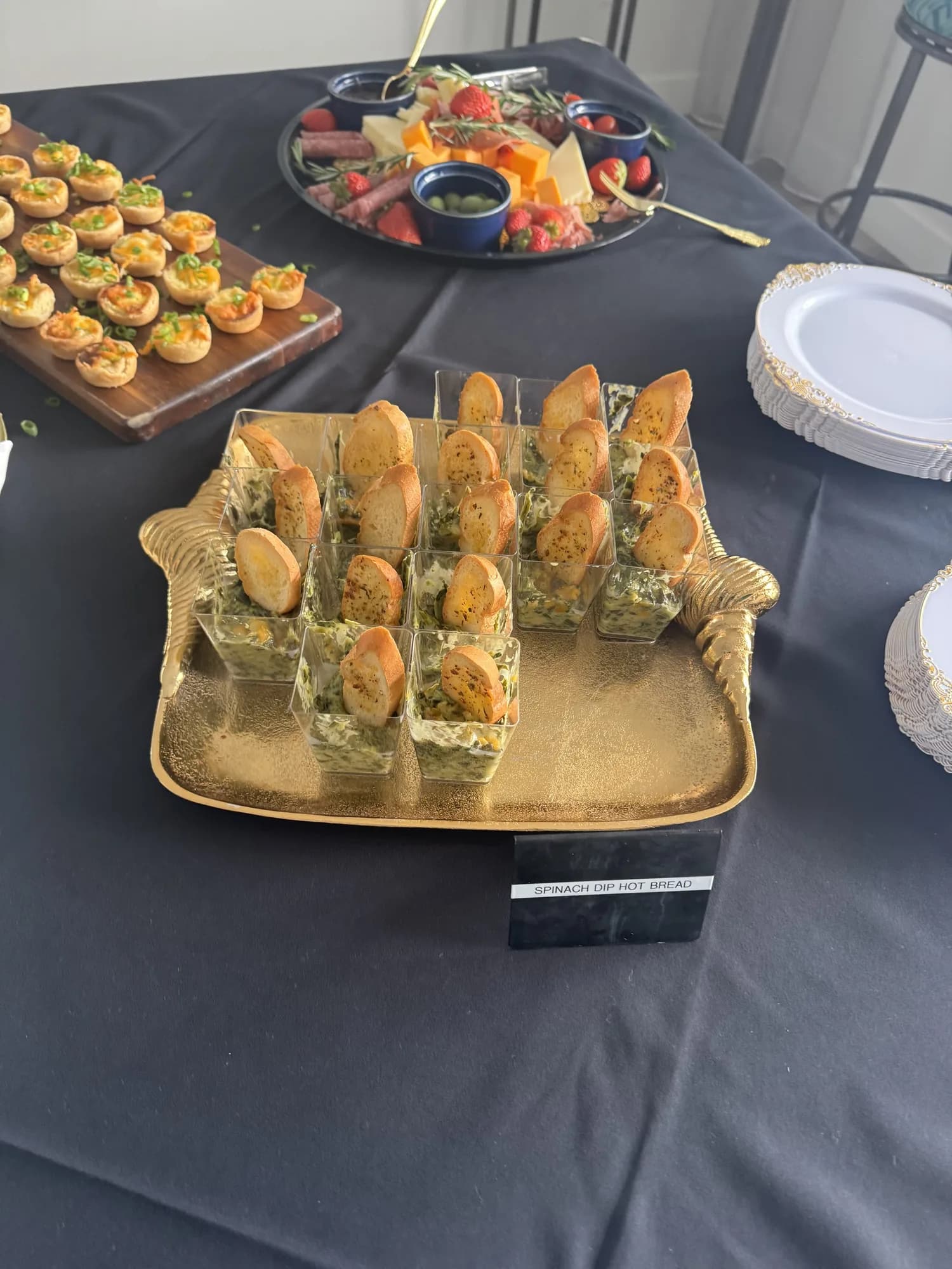 Appetizer cups arranged on a wooden board