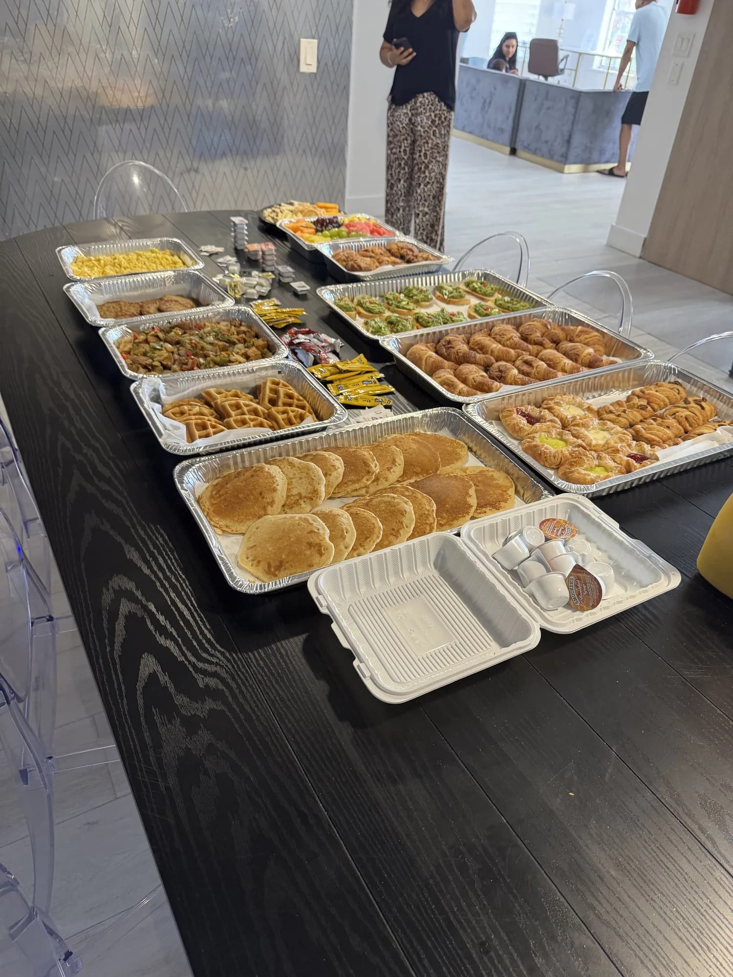 Appetizer trays lined up on black linen