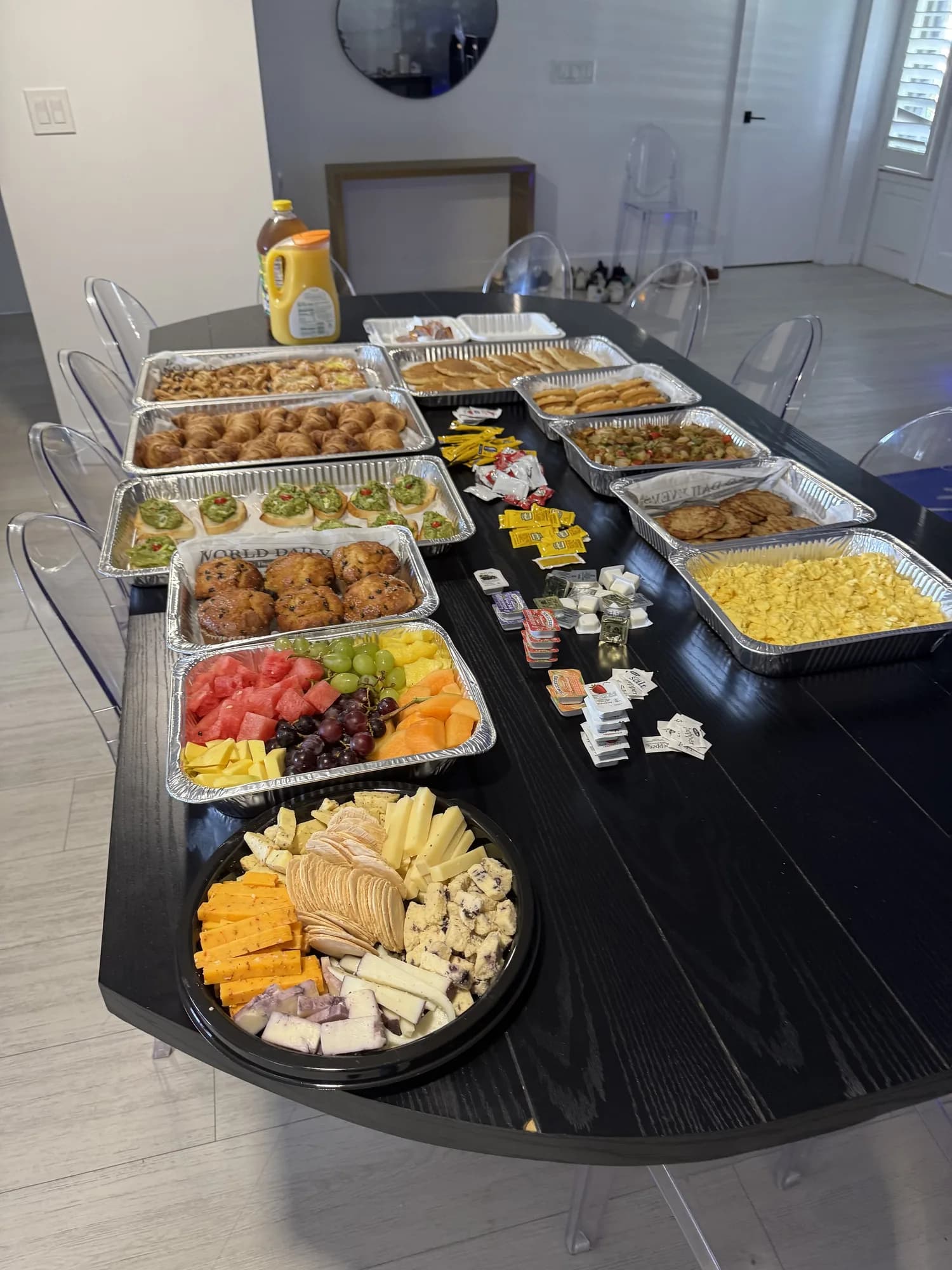Appetizer and fruit trays on a black-draped catering table
