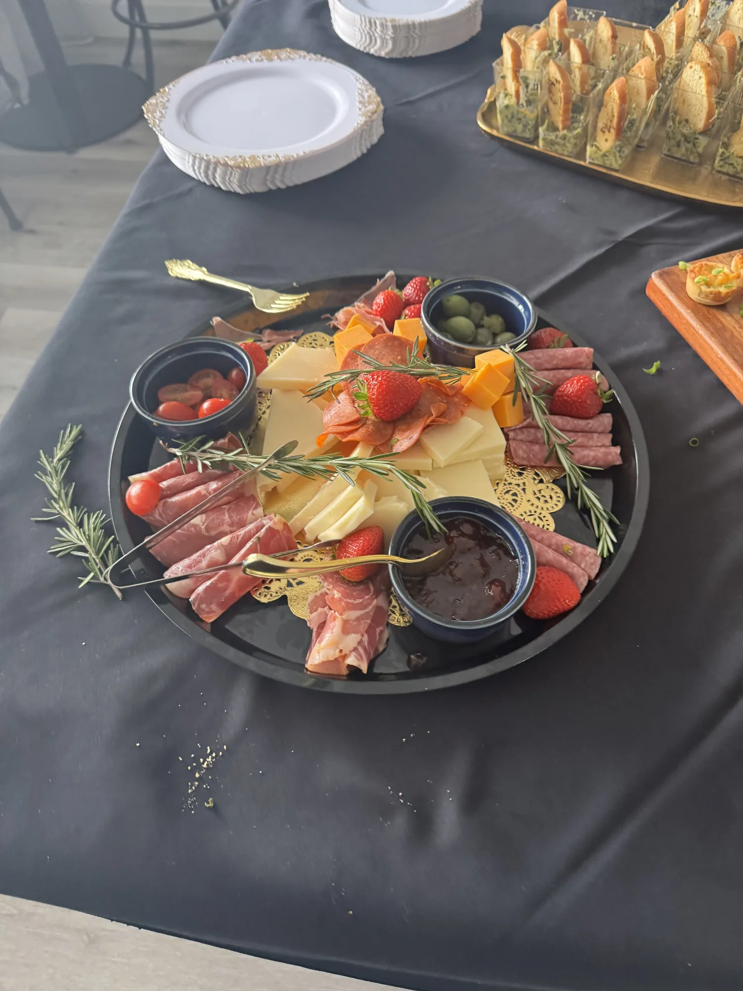 Appetizers on a slate board with fresh herbs