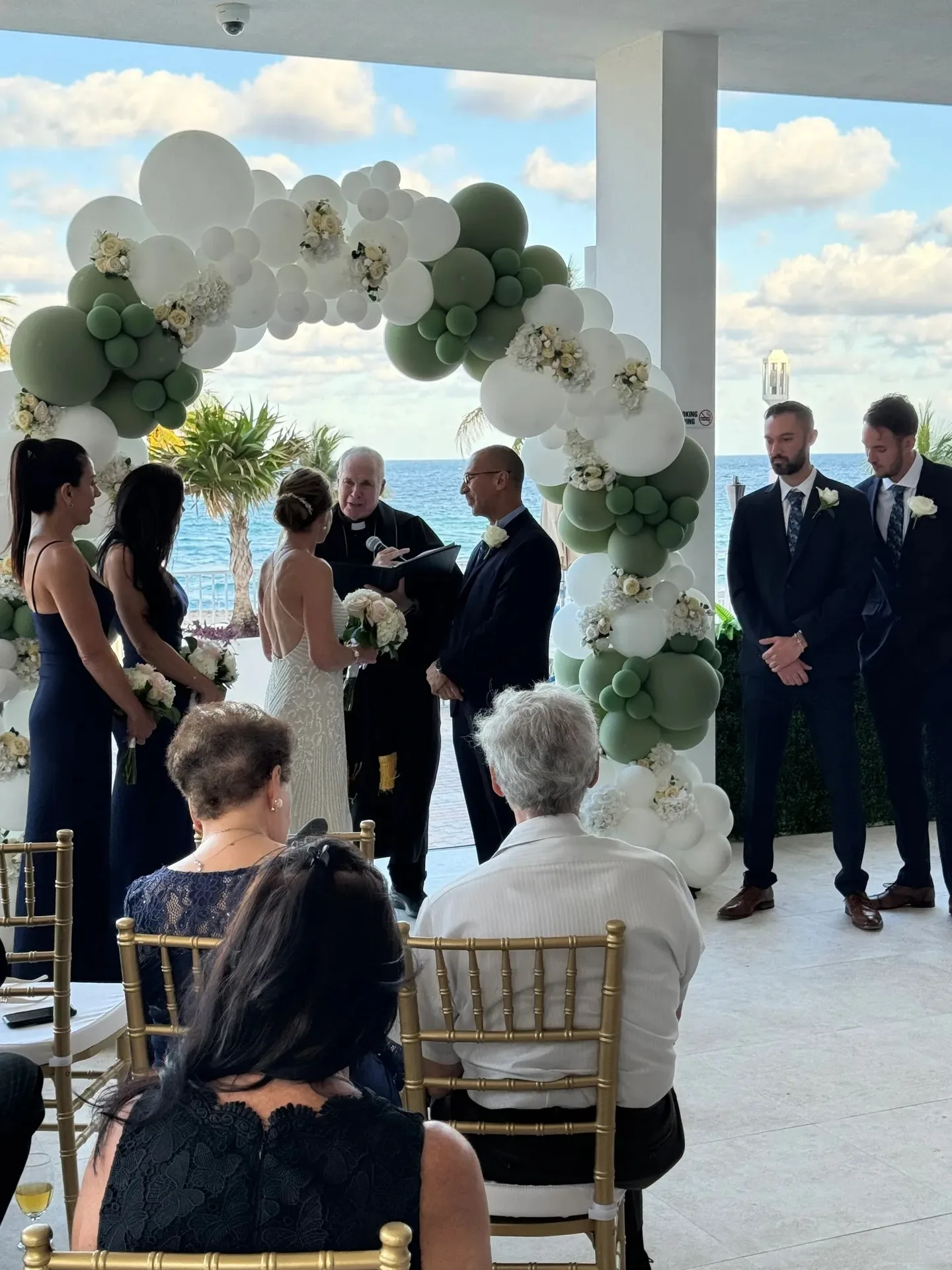 Couple exchanging vows at a beachfront ceremony