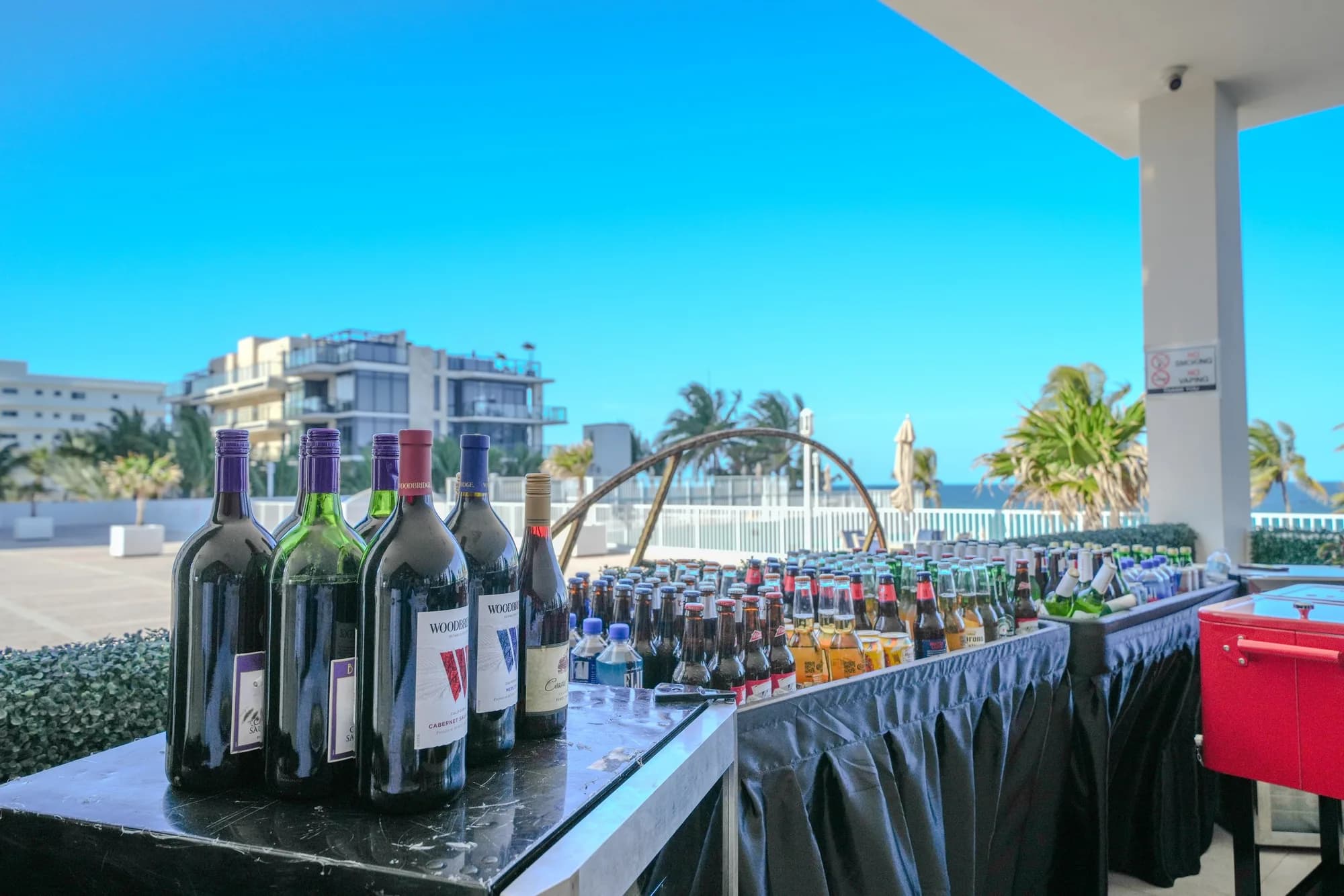 Beachfront bar setup with wine and spirits overlooking the ocean in South Florida
