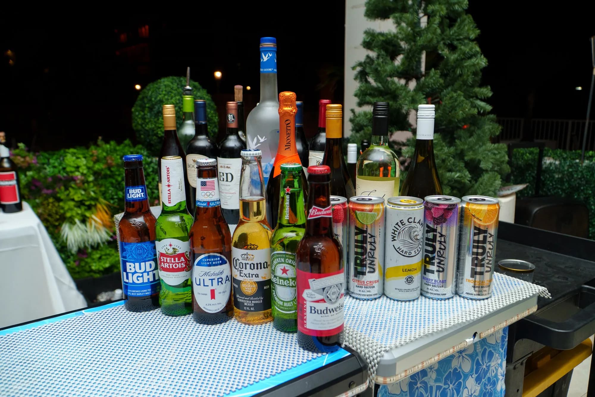 Beer and canned cocktails displayed at an outdoor event bar