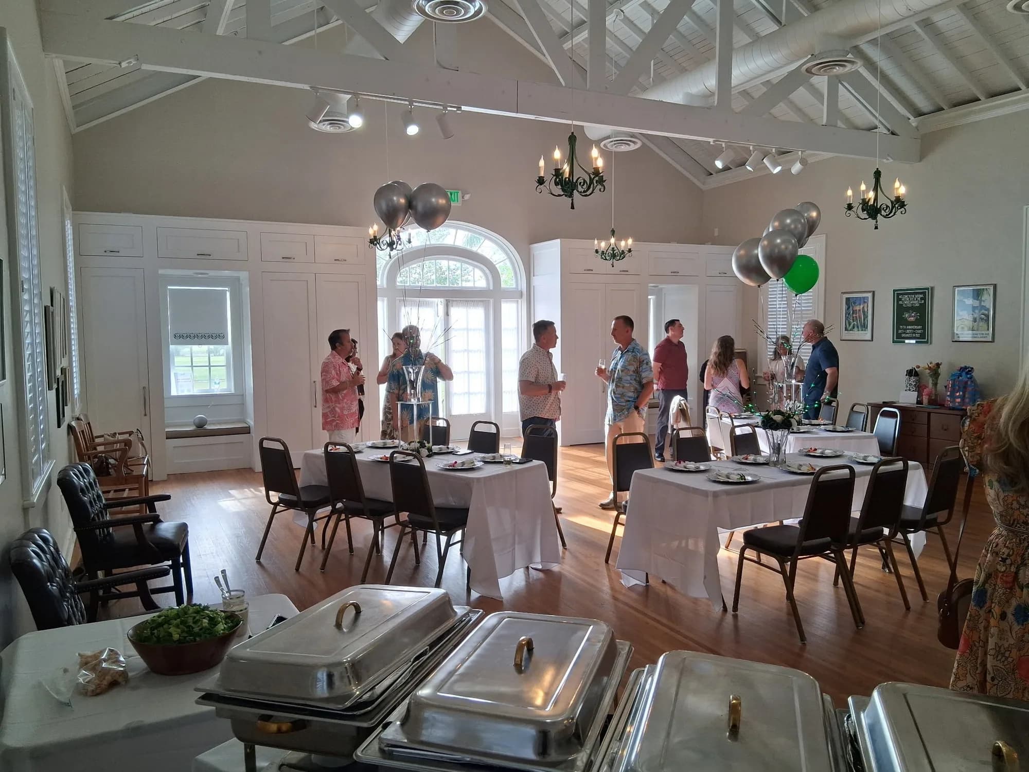 Guests at a birthday party in a hall with a catered buffet