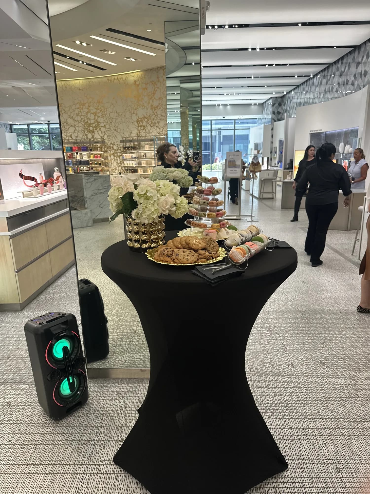 Black spandex cocktail table with appetizers in a corporate atrium