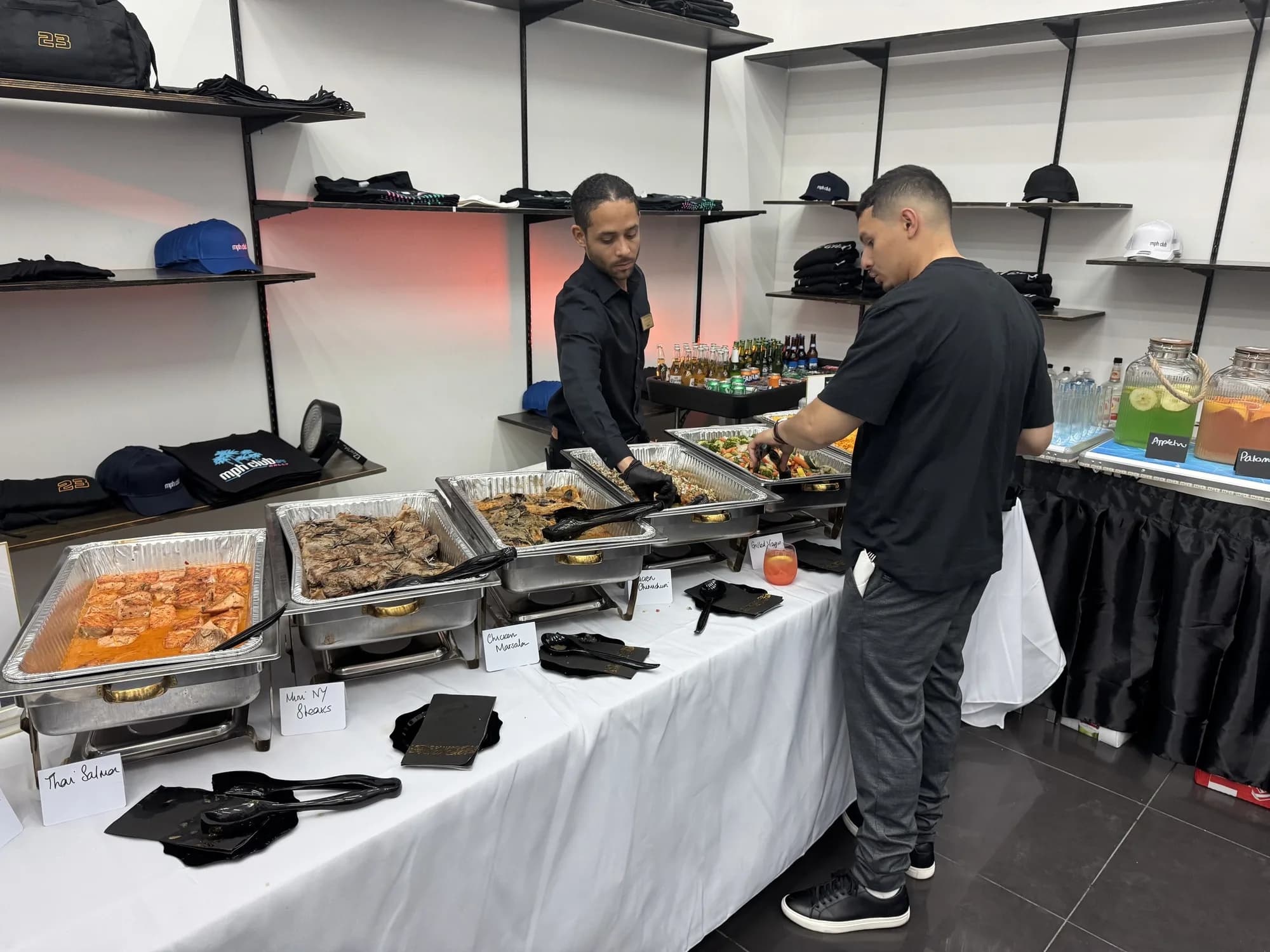 Catering staff serving guests at a buffet line