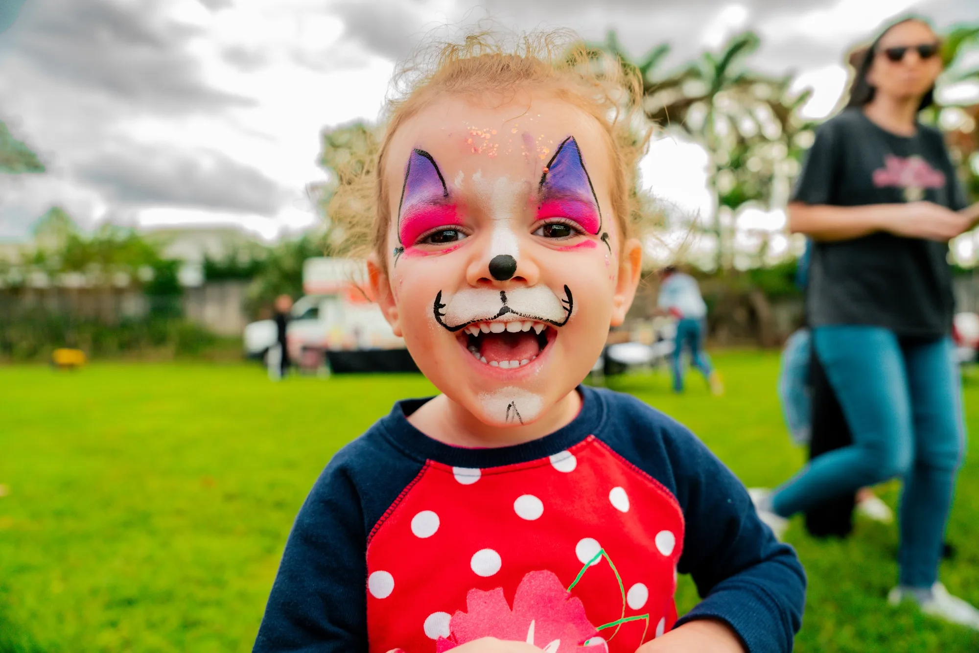 Smiling child with face paint at a birthday party