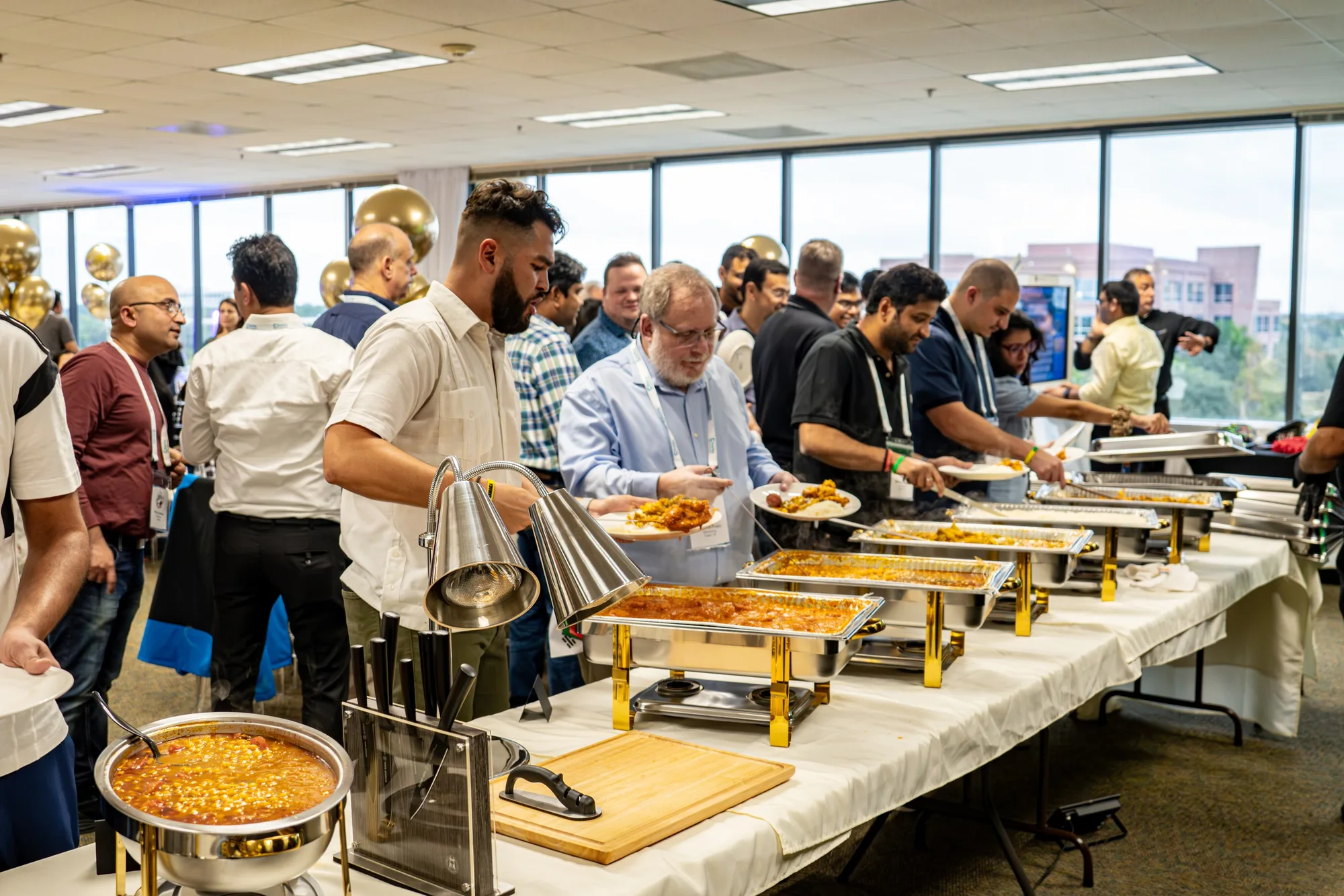 Conference attendees moving through a catered buffet line