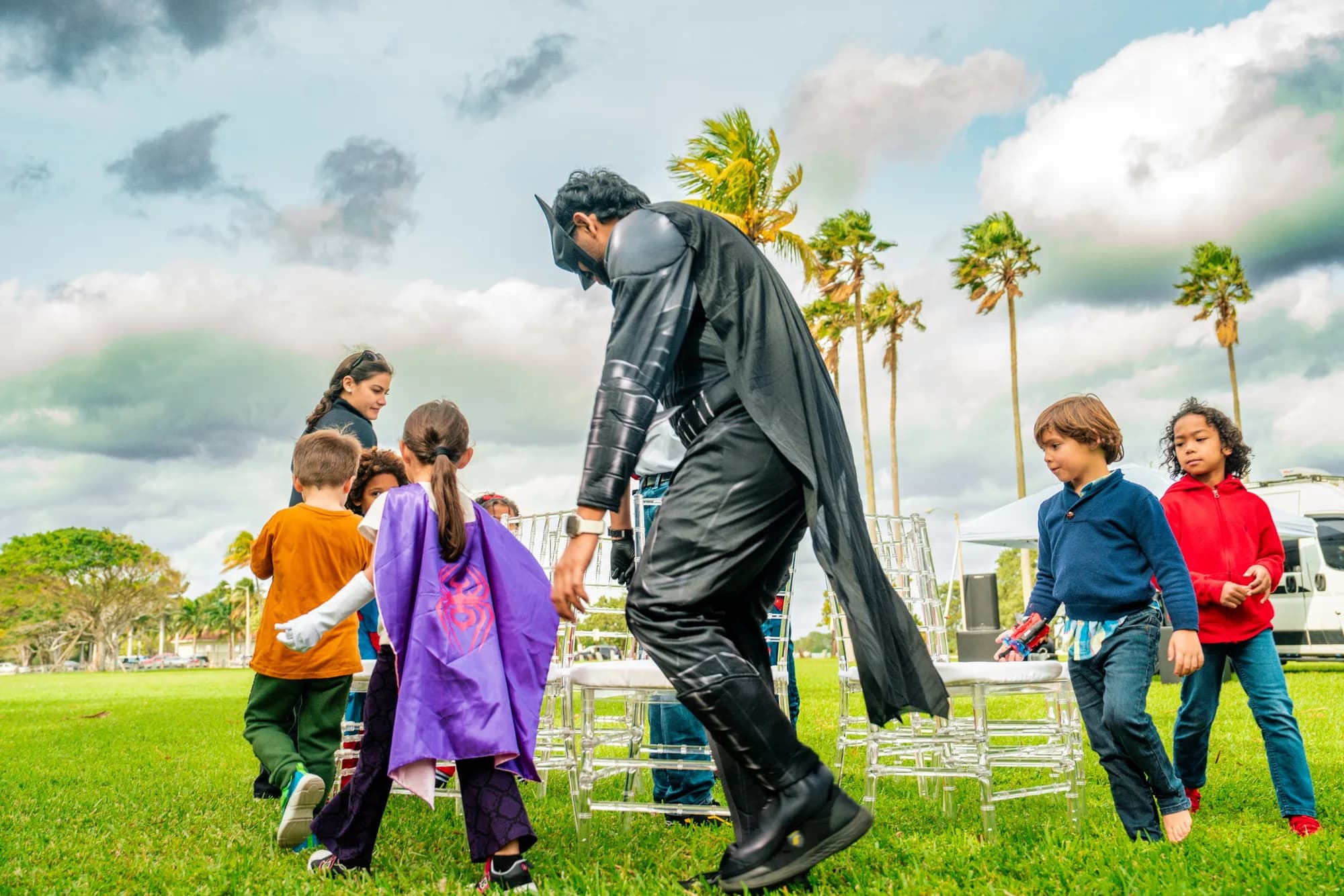 Costumed character entertaining kids on a lawn