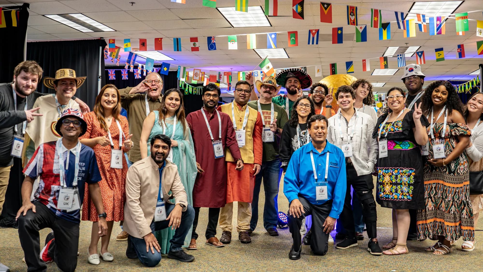 Group photo at a multicultural corporate event with flag bunting