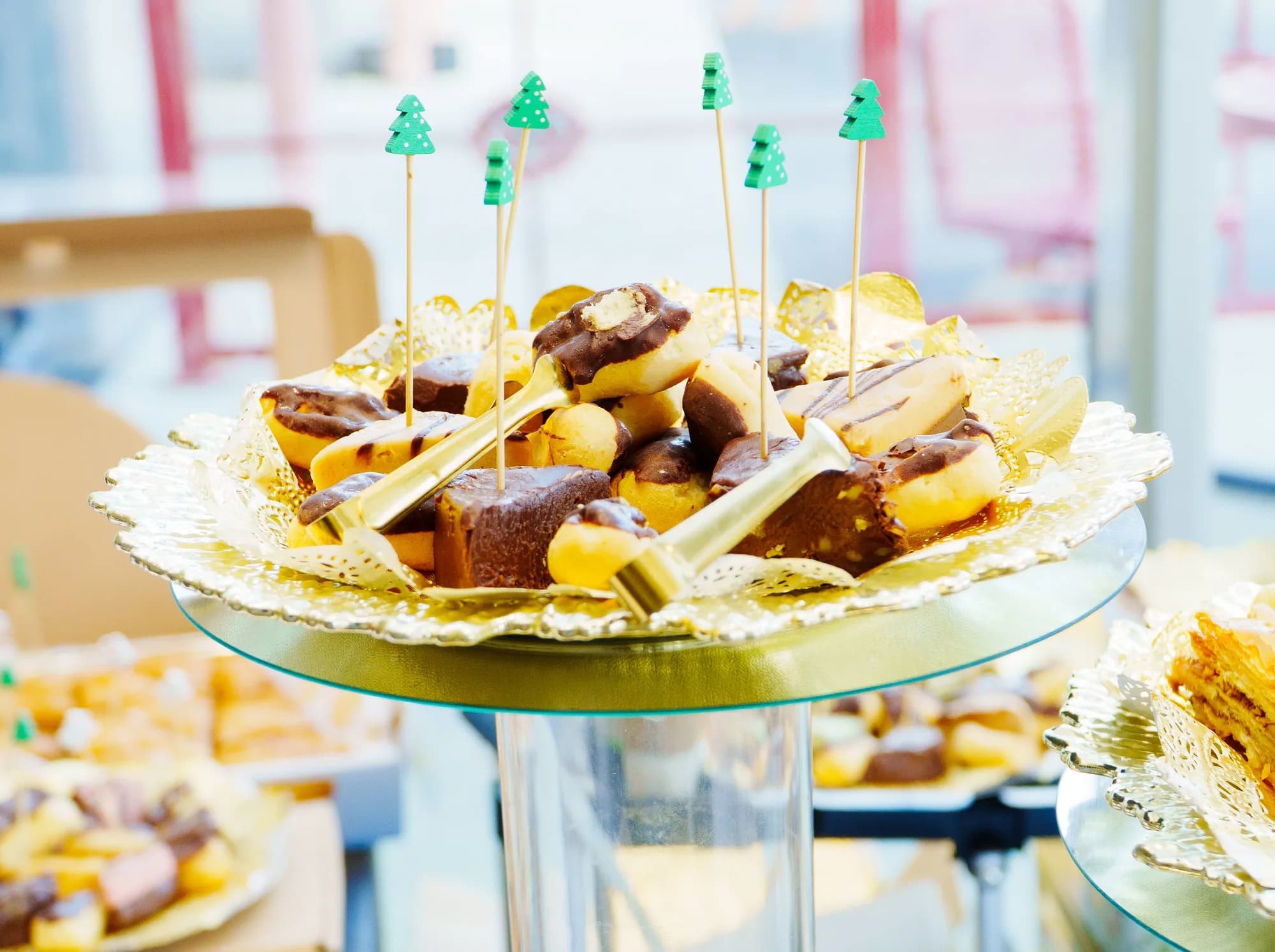 Dessert display on a gold stand at a holiday catered event