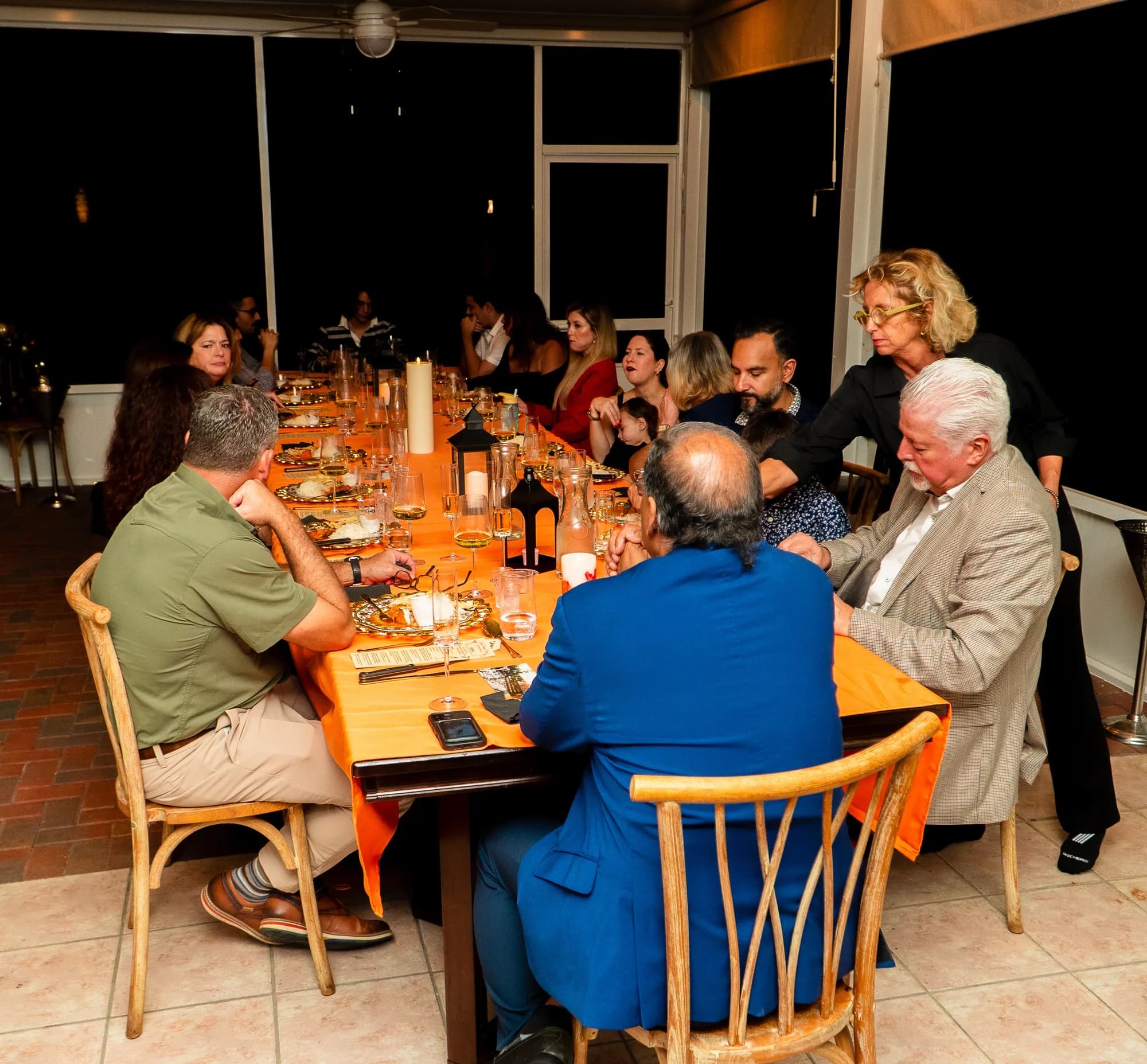 Guests at a long table during a catered dinner party