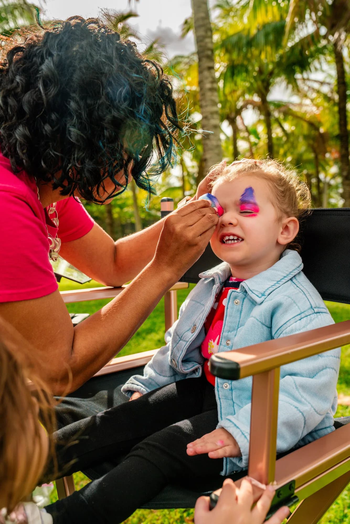 Face painting at an outdoor birthday party