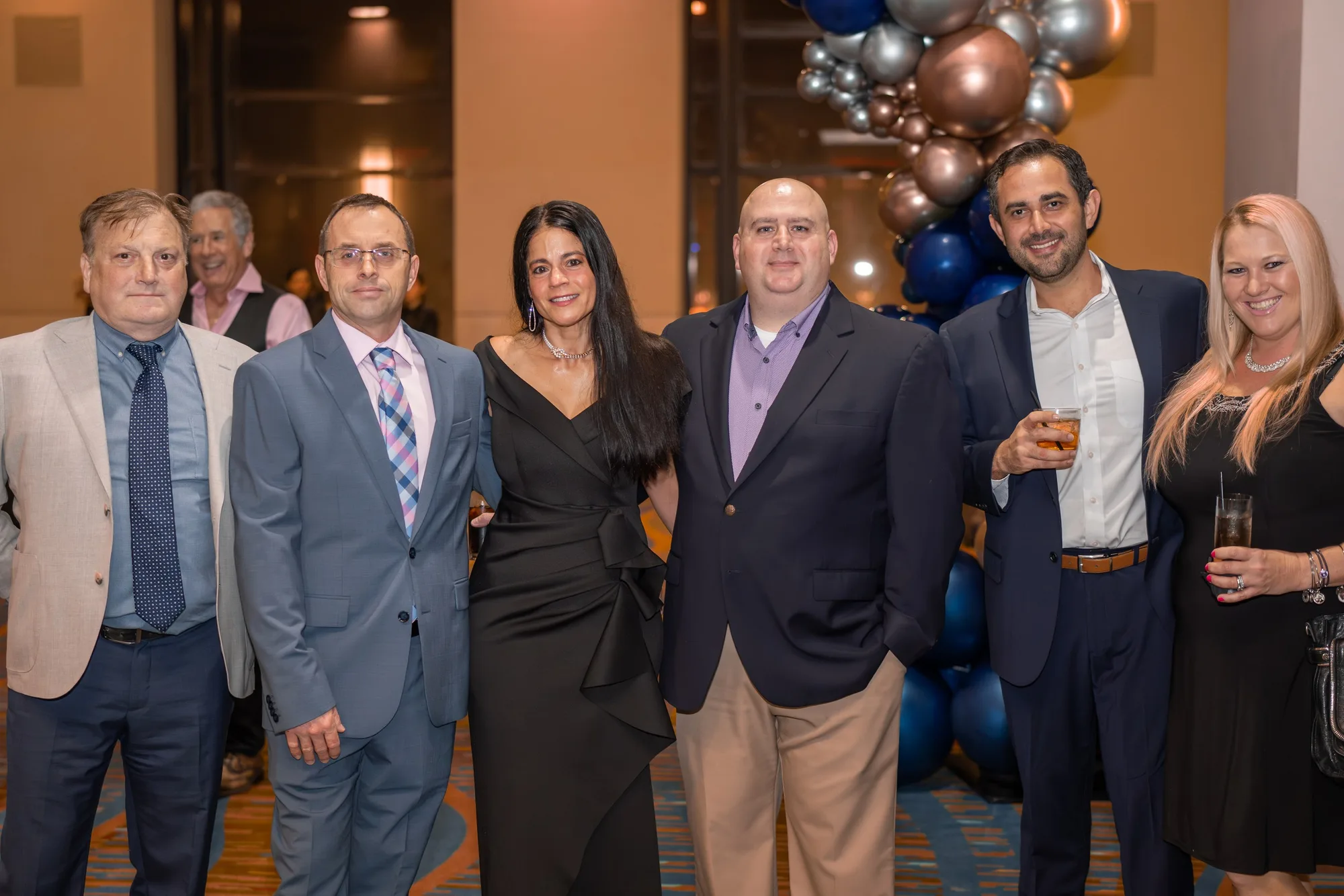 Attendees in formal wear at a gala