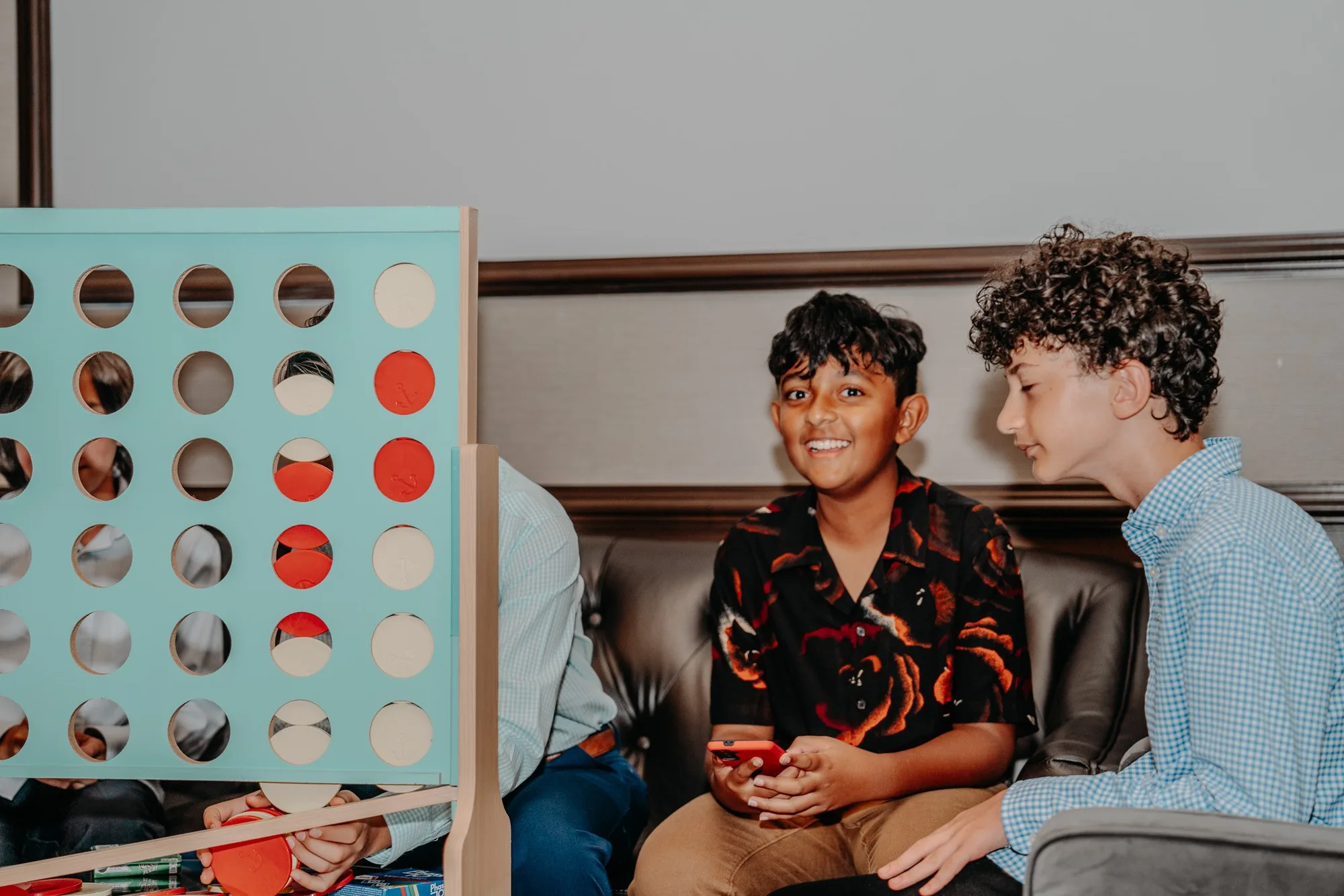 Guests playing a giant connect-four game at a party