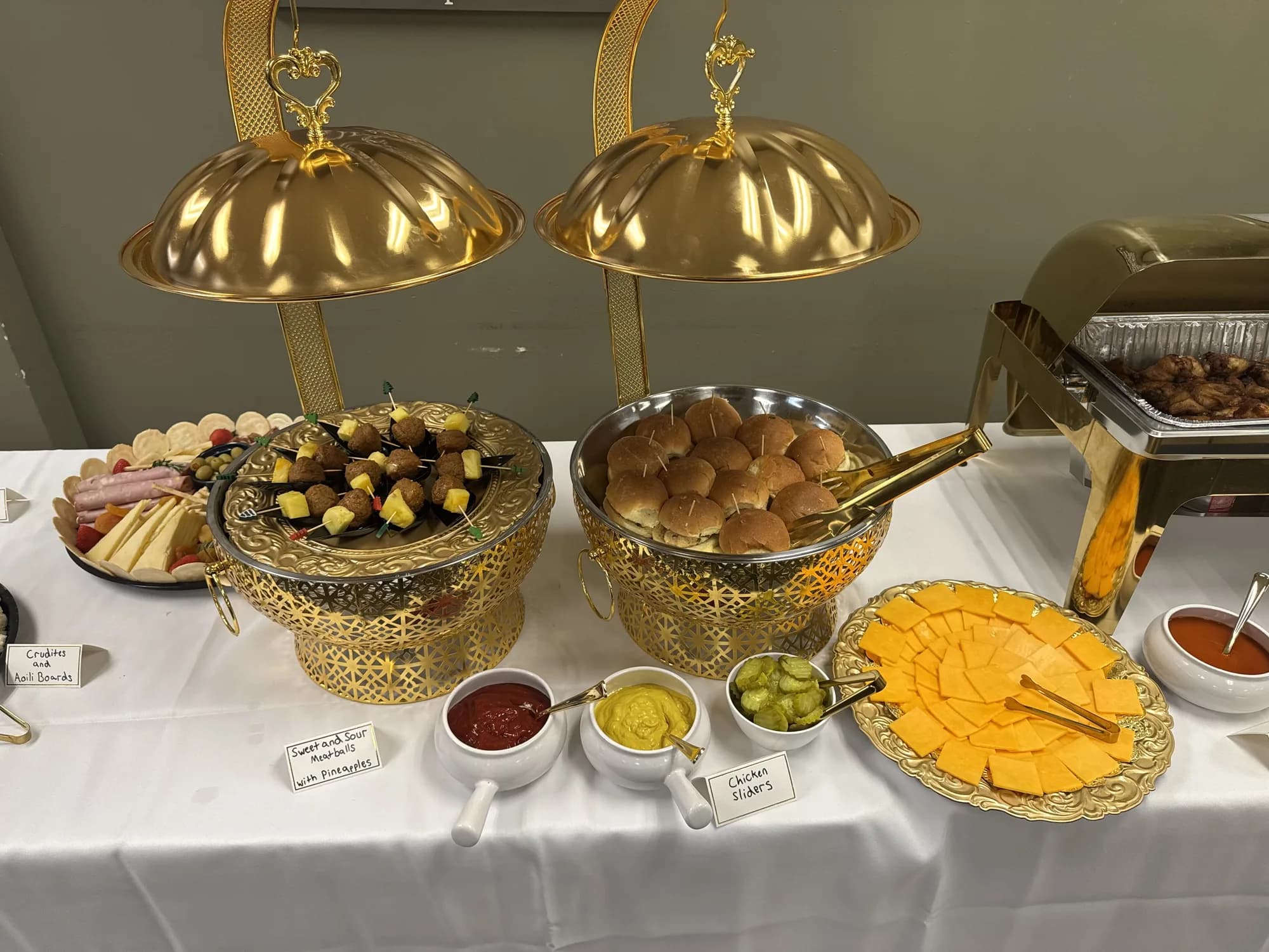 Buffet with gold chafing dishes and hot entrées