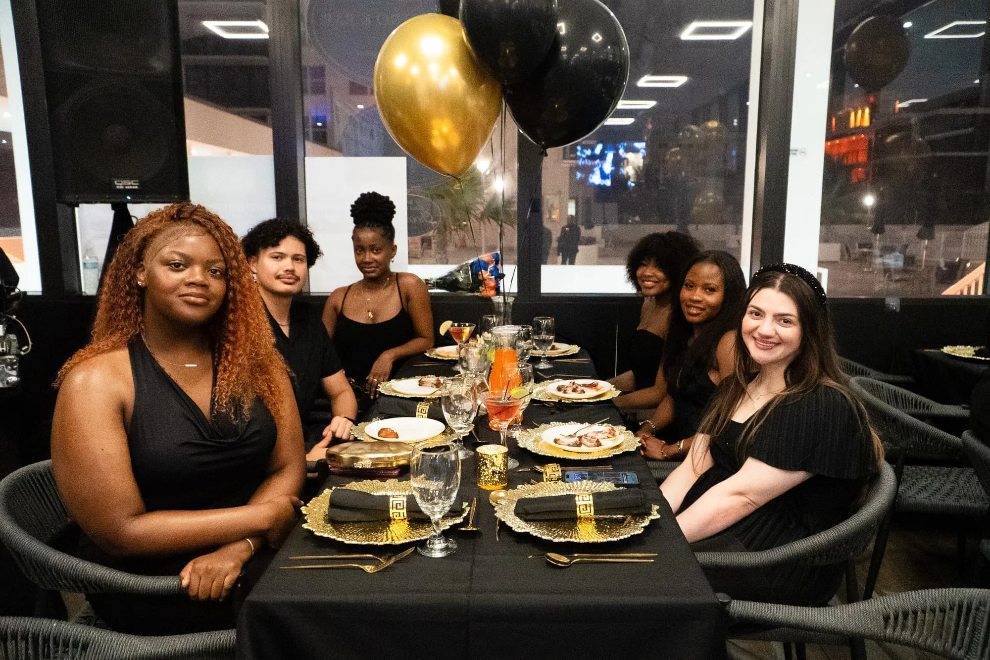 Graduation dinner at a black and gold table setting