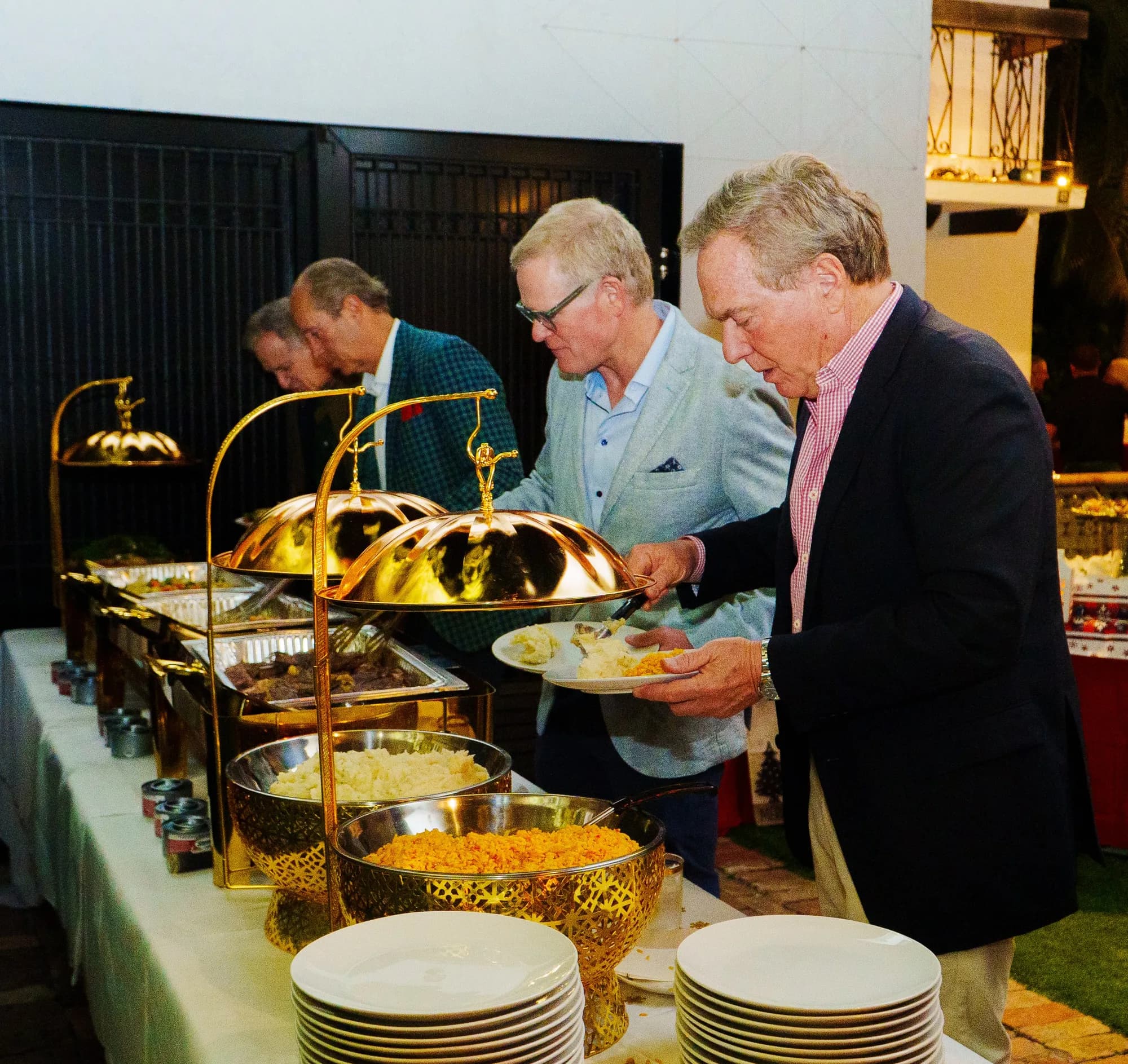 Guests at an outdoor evening buffet