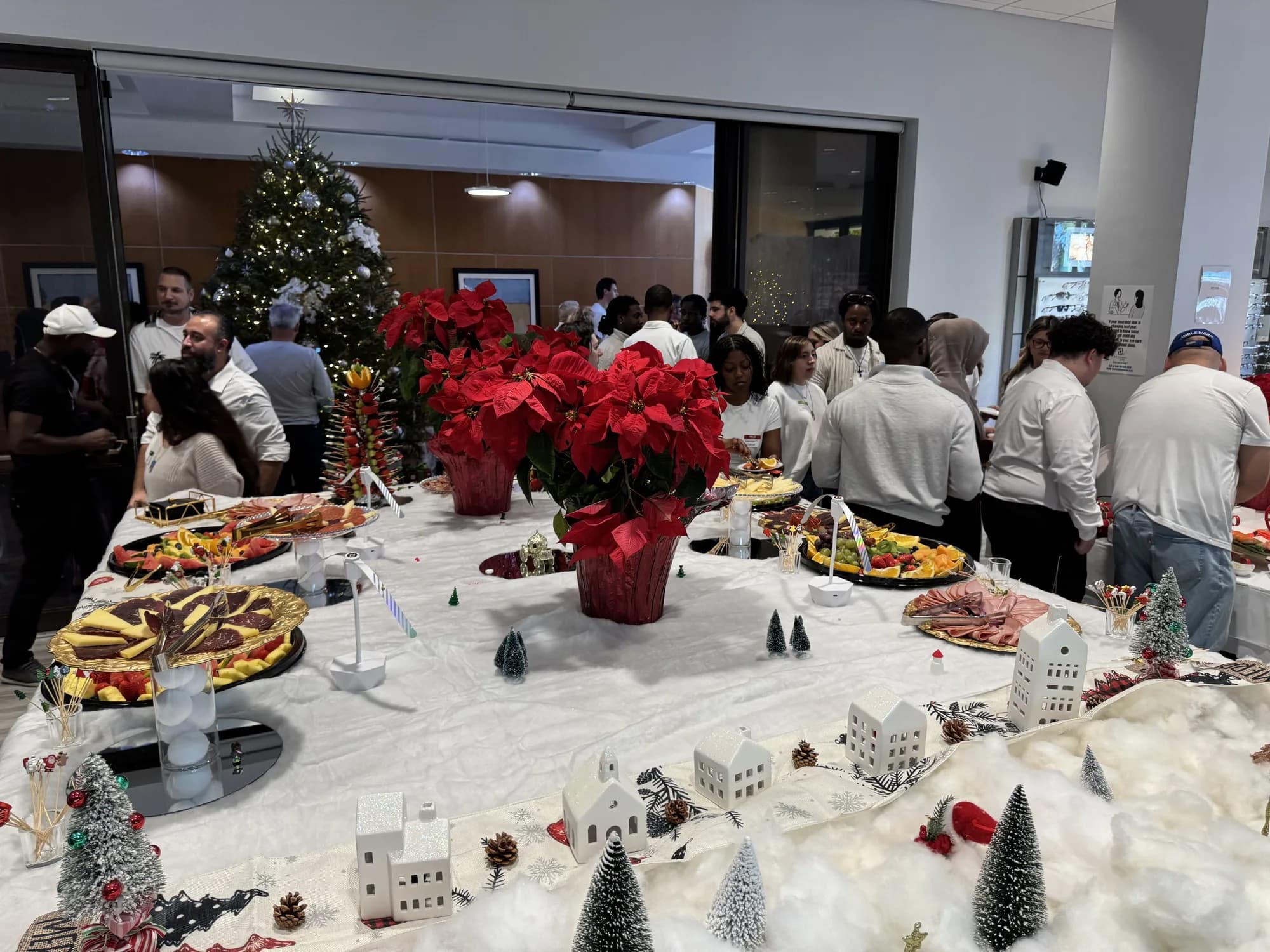 Holiday buffet beside a Christmas tree at an office party