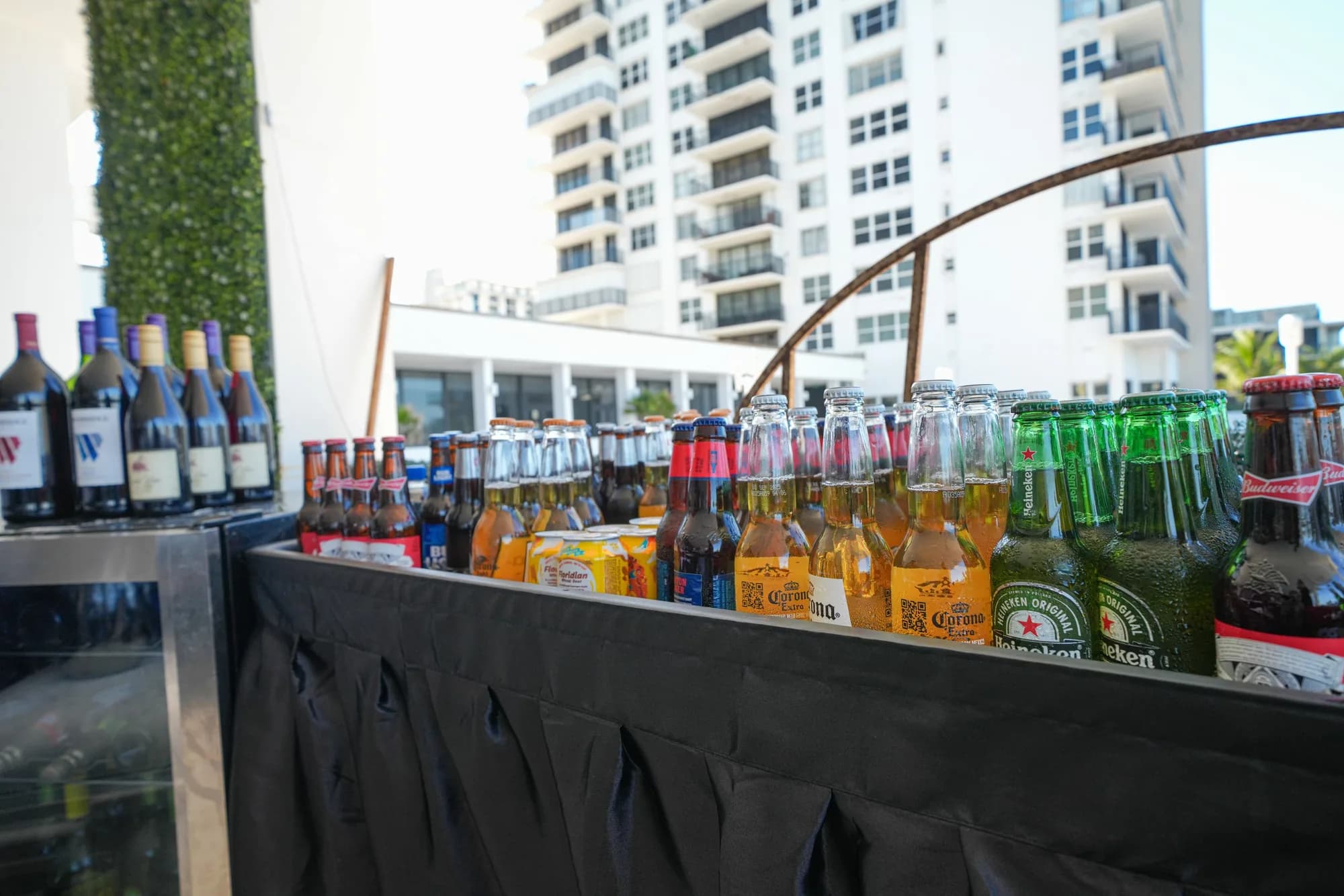 Full-service oceanfront bar with premium spirits and mixers at a catered event