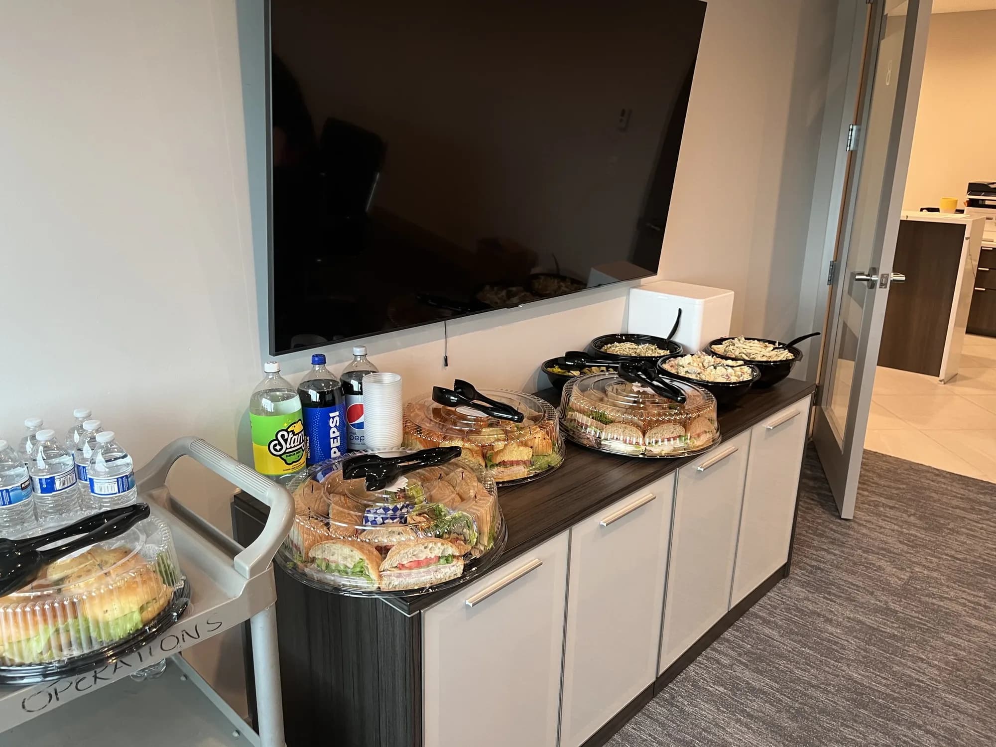 Office catering setup on a kitchen counter for a corporate lunch