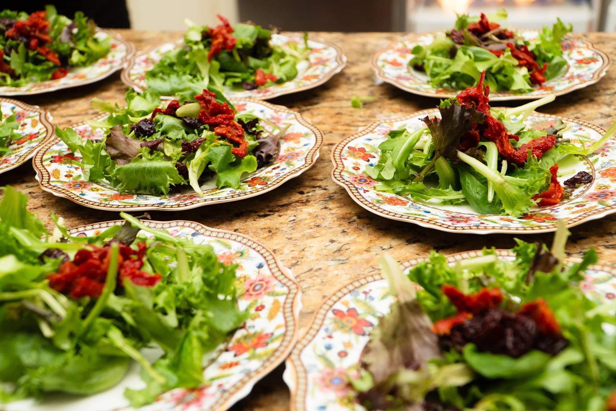Plated garden salads with strawberries ready for a seated dinner