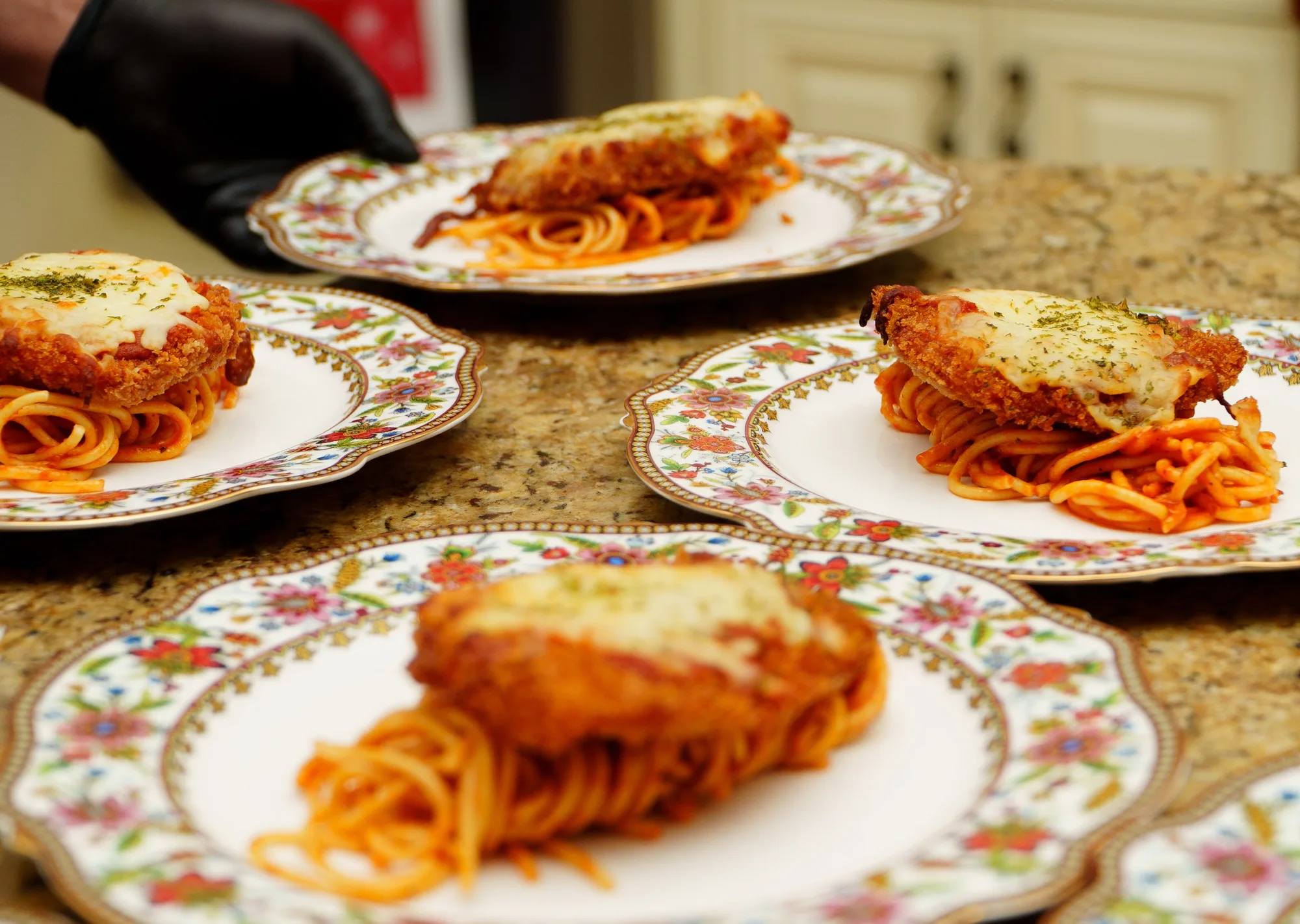 Plated pasta and chicken entrée at a catered event