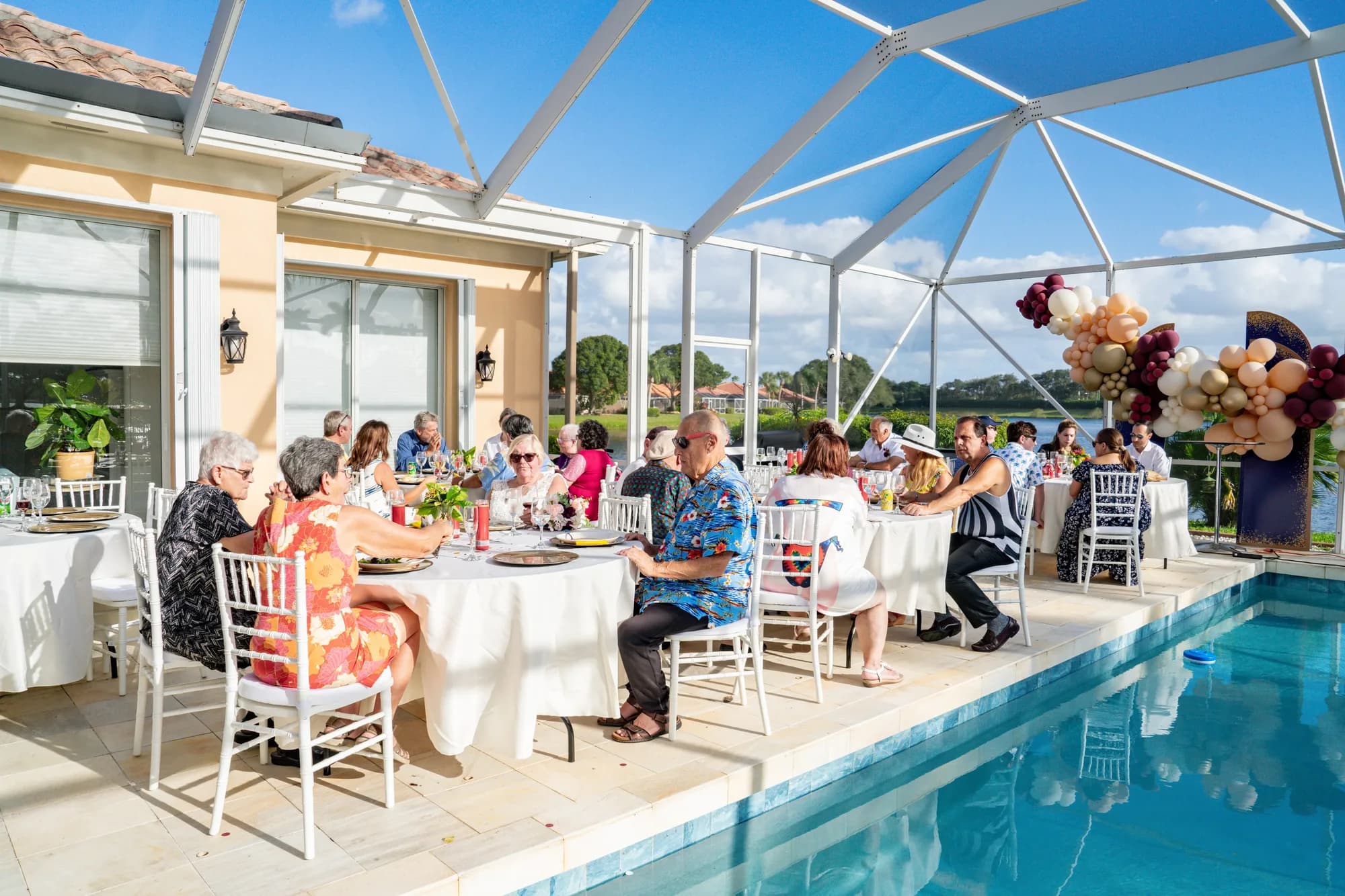 Guests at a poolside wedding reception
