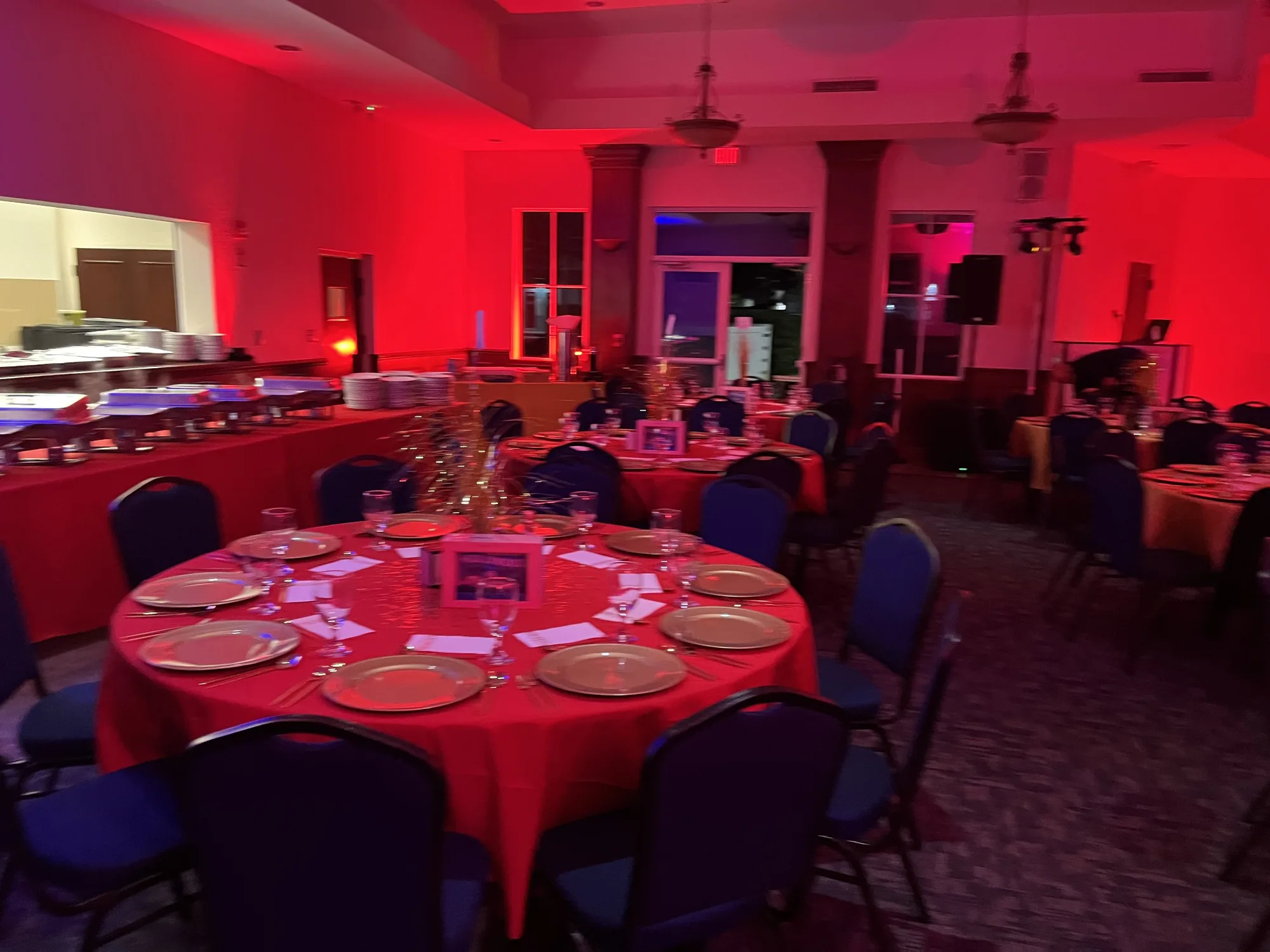 Dining room bathed in red uplighting for a party