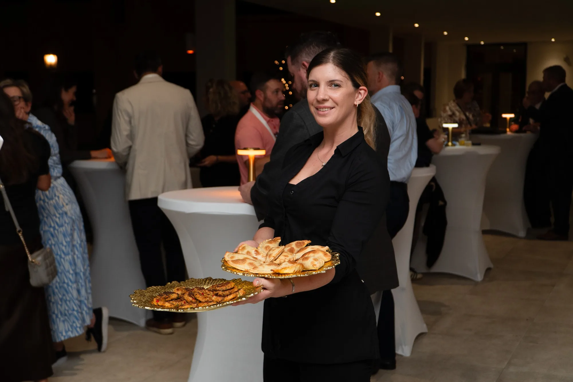Server passing appetizers at a corporate reception