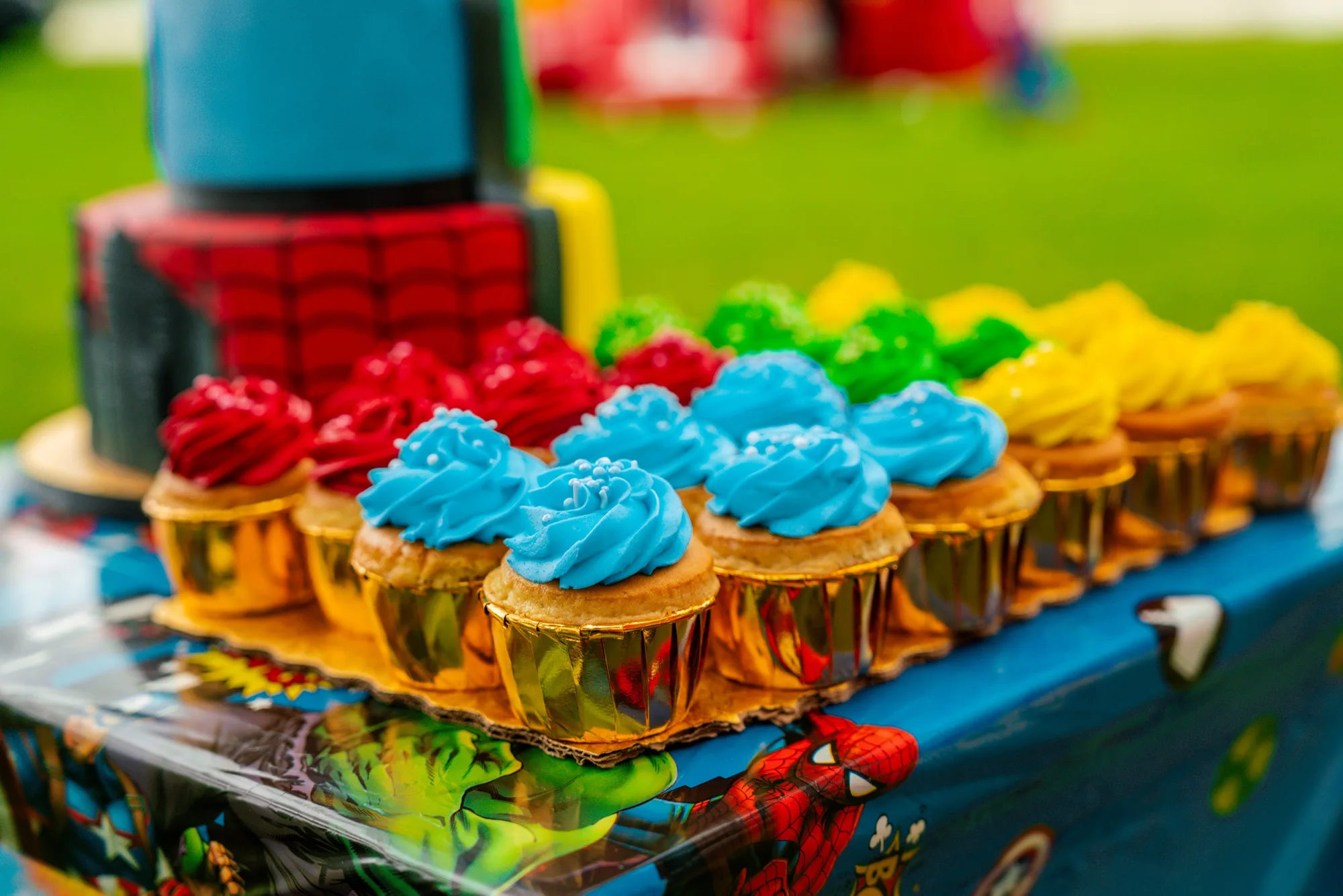 Superhero-themed cupcakes and cake